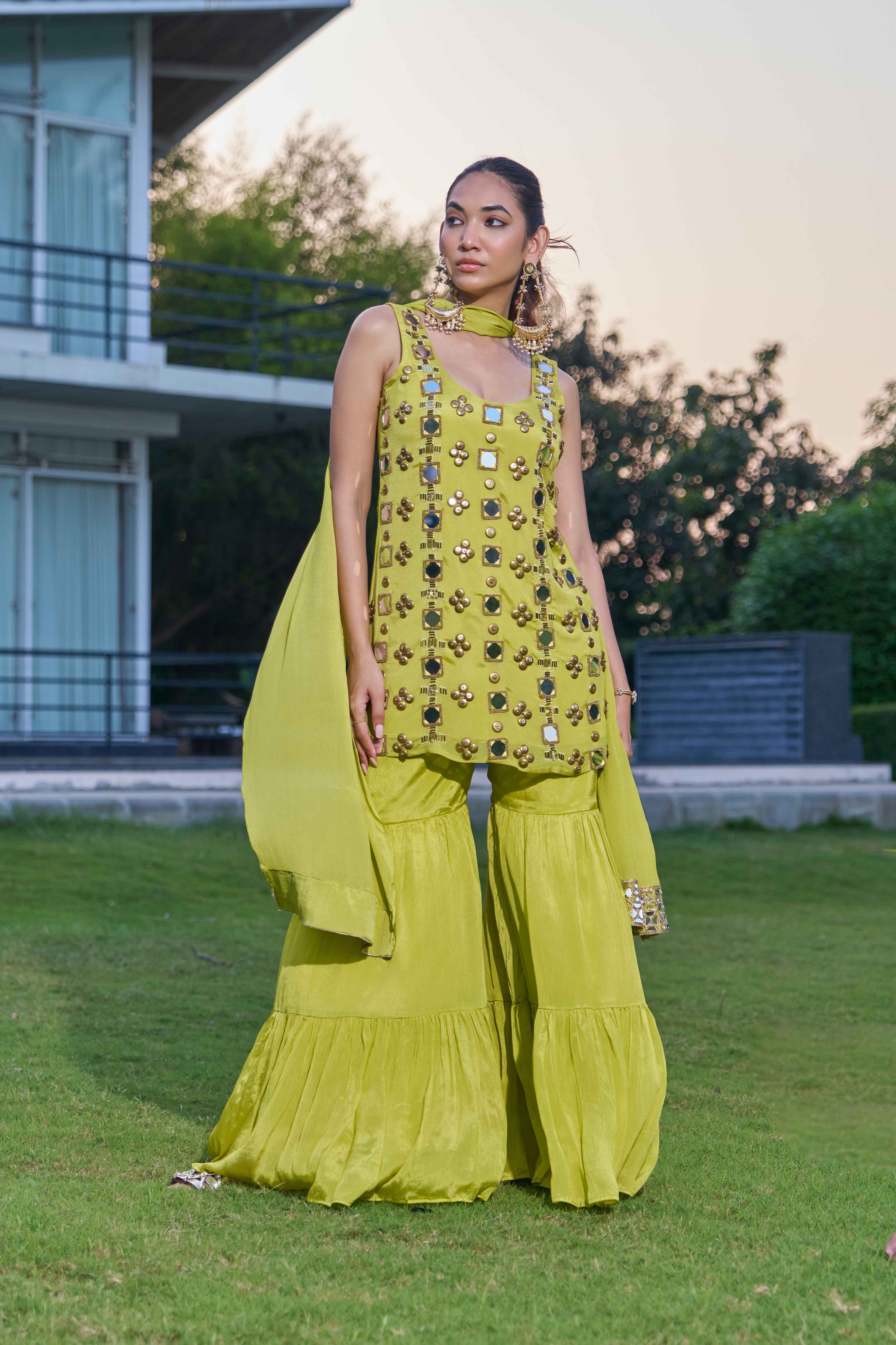 Woman wearing a green sharara suit set