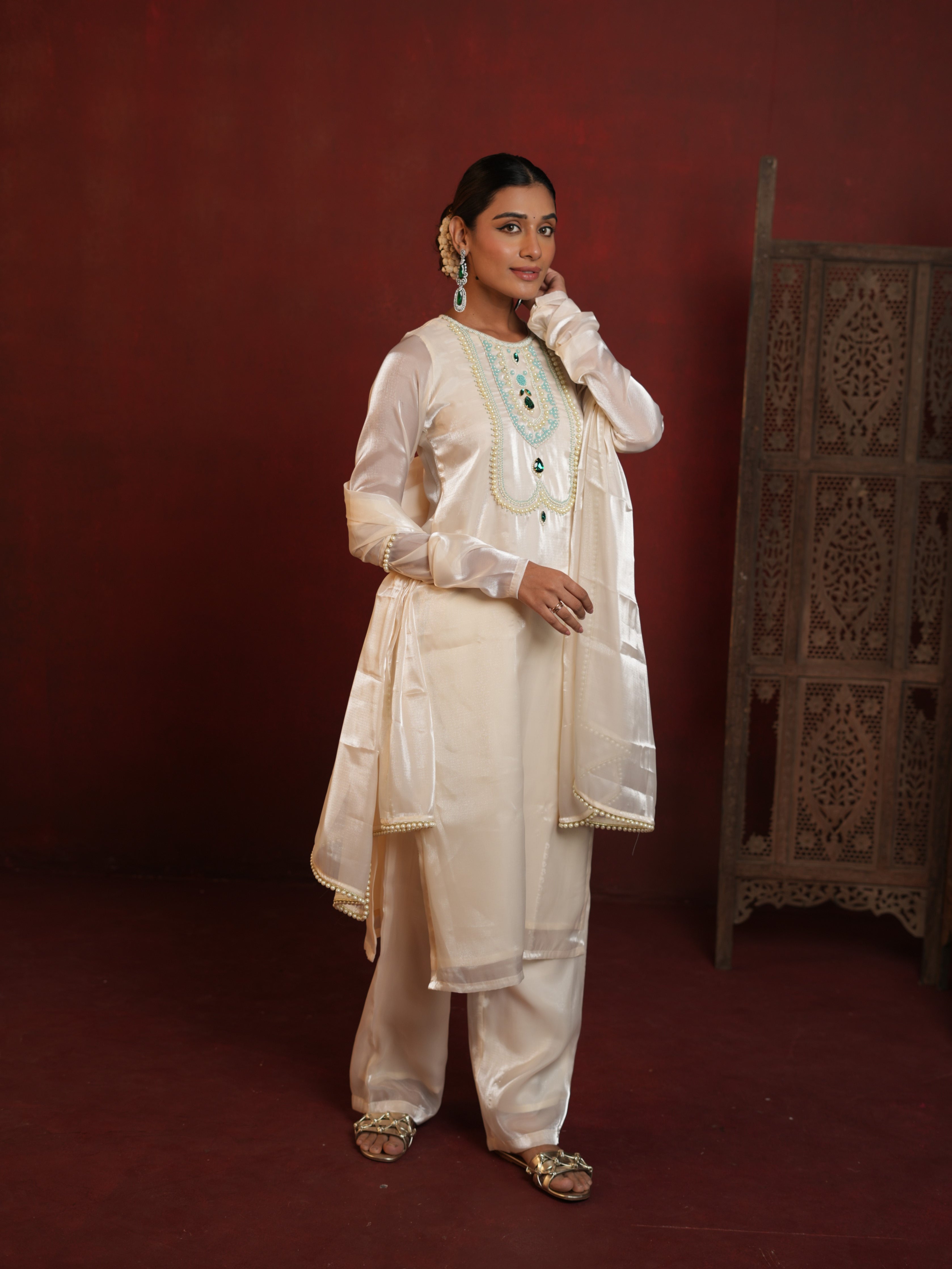 Woman wearing an elegant off-white suit set